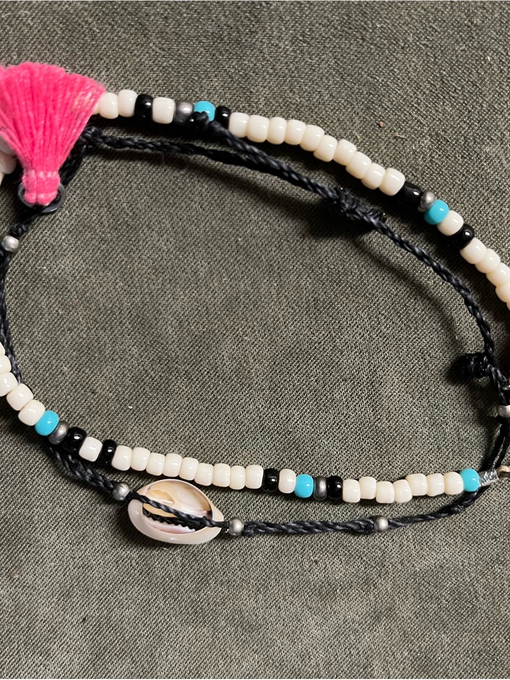 Beaded ankle bracelet with pink tassels, black string adj